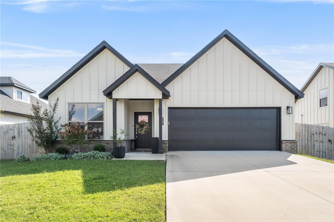 This turnkey, like-new single-level beauty combines modern style with everyday comfort. The black-and-white farmhouse exterior with covered porch and fenced yard sets the stage. Inside, the open layout flows with wide-plank flooring, high ceilings, and natural light.
The chef’s kitchen features quartz countertops, stainless appliances, a gas range, and designer backsplash—perfectly connected to the dining and living spaces. A dedicated office with built-ins and a spacious mudroom/laundry add convenience.
The private owner’s suite offers a soaking tub, tiled walk-in shower, dual vanities, and a large walk-in closet. Secondary bedrooms share a Jack-and-Jill bath with double sinks, perfect for family or guests.
Enjoy evenings on the covered back porch overlooking the fenced yard, or retreat inside to comfort and style. With a two-car garage and a prime location near schools, shopping, and dining, this home truly delivers single-level living at its best-just 10 minutes from the XNA airport.