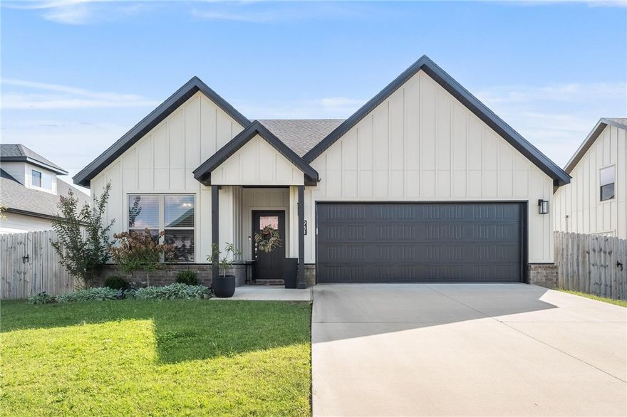 This turnkey, like-new single-level beauty combines modern style with everyday comfort. The black-and-white farmhouse exterior with covered porch and fenced yard sets the stage. Inside, the open layout flows with wide-plank flooring, high ceilings, and natural light.

The chef’s kitchen features quartz countertops, stainless appliances, a gas range, and designer backsplash—perfectly connected to the dining and living spaces. A dedicated office with built-ins and a spacious mudroom/laundry add convenience.

The private owner’s suite offers a soaking tub, tiled walk-in shower, dual vanities, and a large walk-in closet. Secondary bedrooms share a Jack-and-Jill bath with double sinks, perfect for family or guests.

Enjoy evenings on the covered back porch overlooking the fenced yard, or retreat inside to comfort and style. With a two-car garage and a prime location near schools, shopping, and dining, this home truly delivers single-level living at its best-just 10 minutes from the XNA airport.