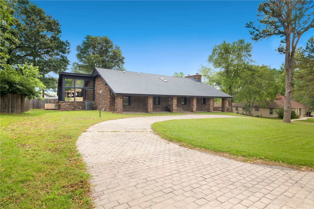 Welcome to 213 Suttle Drive—a beautifully maintained 3-bedroom, 3-bath home offering over 4,200 square feet of living space on a nearly half-acre corner lot. This split-level home blends mid-century character with modern comfort, featuring a large finished basement with two bonus rooms, a bar, fireplace, and laundry area—perfect for entertaining or multi-generational living. Enjoy summer days in the 20' x 40' in-ground pool (resurfaced in 2018), relax in the indoor hot tub room, or host guests in the expansive patio space. The oversized garage can accommodate up to six vehicles.
Located in a quiet Springdale neighborhood near trails, Lake Fayetteville, and just minutes from shopping and the University of Arkansas, this one-of-a-kind property offers space, function, and location.