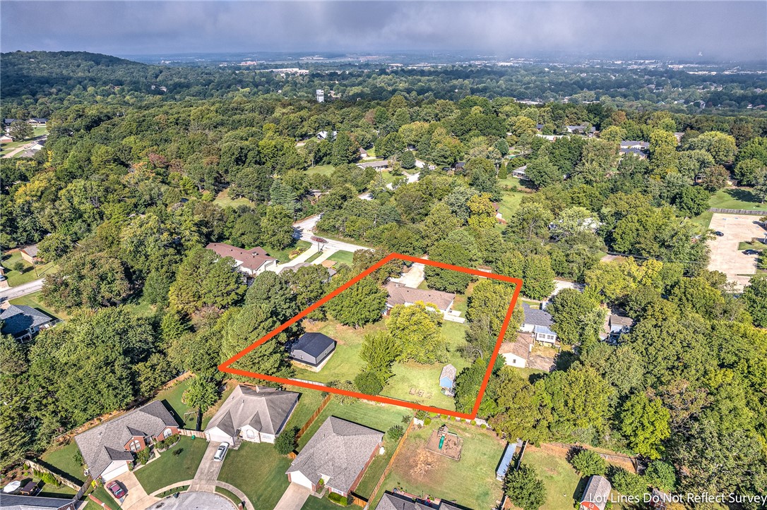 Discover your slice of serenity in the heart of Fayetteville! This beautifully remodeled home, boasting almost an acre of land, offers the perfect blend of suburban bliss and city convenience. With a generous 900-square-foot shop and mature trees adorning the property, you'll have room to explore and pursue your hobbies. Step inside to find a thoughtfully updated interior, with a total remodel of the primary bath and closet, as well as new windows that usher in natural light. Working from home is a breeze with a dedicated office space. This 4-bedroom, 2-bathroom home spans 2,091 square feet, providing ample space for all your needs. Enjoy the luxury of a tranquil retreat within walking distance to Gulley Park and Butterfield School. It's just a little bit of country living, yet oh-so-close to the city. Don't miss your chance to make this exceptional property your new home!
