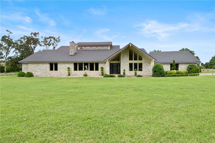 Best of both Worlds describes this 8.37 acre gated estate located halfway between Downtown Rogers and The Pinnacle Area.This home is perfect for entertaining or just family living with 4 bedroom, 3.5 baths, 2 large living areas. Great open floorpan with tall ceilings and skylights. Gunite Pool with large covered patio area. Heat and Air shop building for the motorhome and all the toys, 36X100, plus 8X100 covered area on each side. Close to everything NWA has to offer, Trails,Lakes, Museums. This is a must see piece of property that is in perfect condition. Call today for private showing.