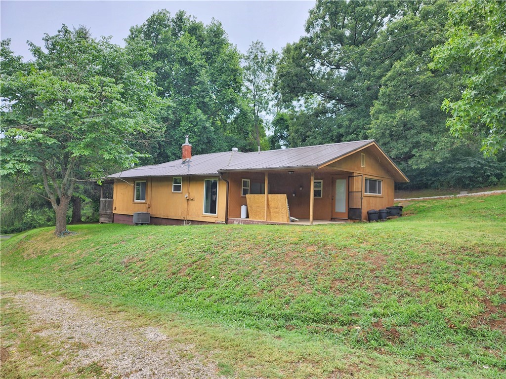 Check out this stunning property in West Fork! This home and its surrounding acreage are full of charm. Conveniently located just 1.9 miles east of Business 71 and West Fork, with paved roads leading straight to the house. Enjoy the covered front porch/deck overlooking the front yard. Inside, you'll find a spacious family room with a wood-burning stove. The wood ceilings and walls provide a cozy, cabin-like atmosphere. The eat-in kitchen also features a wood ceiling. The large master suite boasts an open design, leading to an oversized master bath with a separate shower and tub. The home has a metal roof and vinyl windows, both installed around 2009.