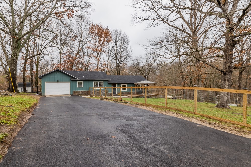 Newly remodeled home on over an acre with 4 bedrooms 2 full bathrooms, pantry, office and open floor plan all just a short distance from downtown Bentonville! The home has a roof that was replaced approximately 2 years ago, new siding, windows, doors, flooring, fixtures and appliances along with new HVAC and hot water heater! Over 400 square feet of living space was recently added as well as additional fencing, asphalt on the driveway and concrete walkway. There are 2 decks on the home, one is covered and in the backyard there are large trees and a small spring fed creek! Come see this beautiful Pea Ridge home!