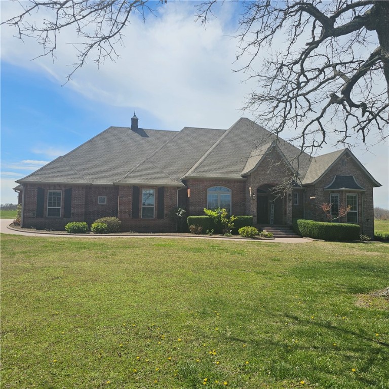 Estate home sitting on 12.18 acres. All open and level except perimeter with wooded acres. Great for feel of seclusion, yet close to town. Less than 1/2 mile of gravel road. Shared pond. 4 or could be 5 BR home. All on one level except Theatre/Media/Game room upstairs w/ large walk-in closet for storage and/or media equipment. 110” movie screen w/projector, rope lighting and surround sound. Massive custom trim package w/crown molding & wood window toppers. One owner custom built home in 2007. All appliances stay, including Gas propane countertop stove, microwave/convection/conventional oven, ice machine, built in warming drawer/slower cooker, trash compactor, vented hood, dishwasher, smart refrigerator, washer/dryer. Gas log fireplace & mini-split in enclosed patio with shake shingles on walls & real wood ceiling for lodge like setting. Upgraded electrical and plumbing fixtures, heated whirlpool tub,2 lg walk-in closets, separate stool area, and sep shower. Oversized 3 car garage & much more. Agent Owned