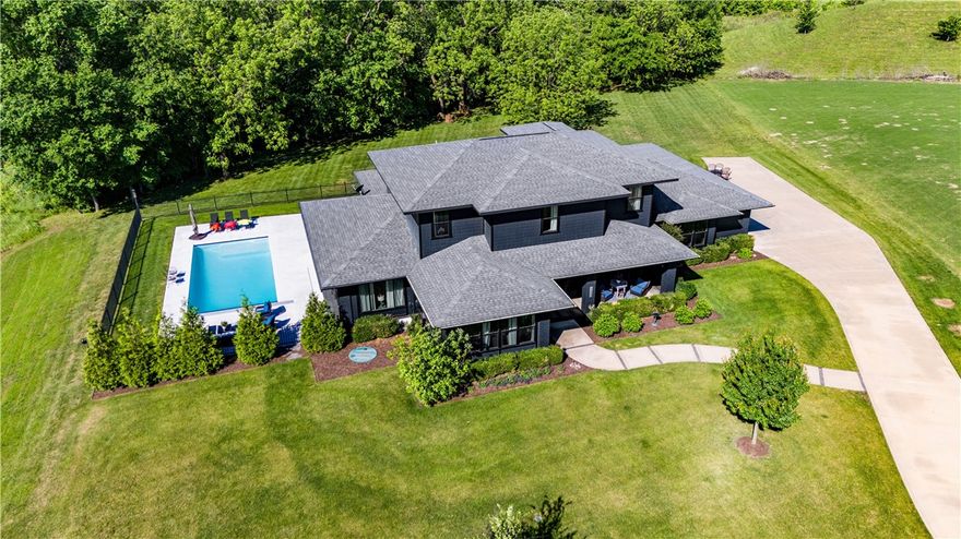 You're not going to want to miss this beautiful custom-built home in Centerton! A spacious 4-bedroom, 3.5-bathroom home that offers 4,162 sqft of modern living on a large 1.16-acre lot. Enjoy the peace of mind with a hidden safe room rated for EF5 tornadoes! The master bathroom features heated floors for those chilly mornings while the living room flows into a sunroom with access to an outdoor pool with an electric cover. Lennox high efficiency, with air scrubbers and blue light and tankless water heater with water softener. Surrounded by green space in a quiet, gated community, this home provides a serene and private setting. Perfect for those who appreciate both luxury and tranquility.