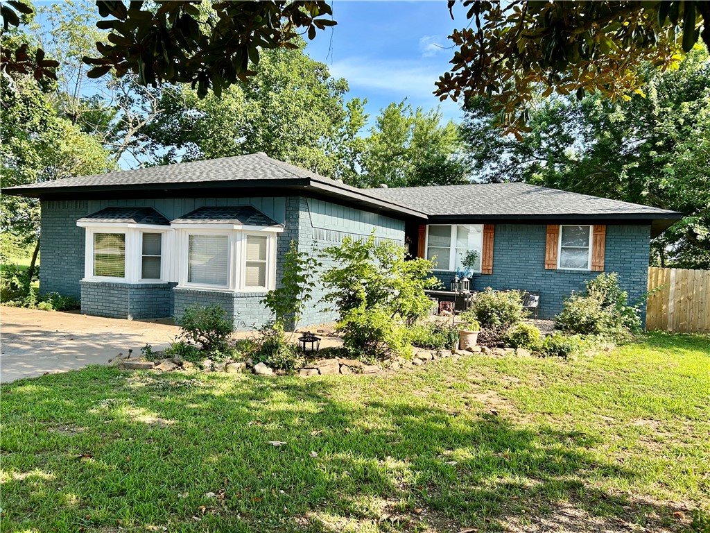 Newly remodeled country charmer on 1 acre with mountain and views! This beautifully updated home features a chef's dream kitchen with granite countertops, farmhouse sink, coffee bar, stainless steel appliances, and a spacious walk-in pantry with built-ins. The freshly renovated bathroom includes a jetted soaking tub-perfect for relaxing tired muscles after a long day. Enjoy two spacious living room and a den with a wood burning fireplace ideal for entertaining or quiet nights in. Step outside to unwind on the built-in porch swing, side patio, or front porch, and soak in the serene countryside views. In the backyard, you'll find a few fruit trees, a muscadine vine, and a dog pen. Out front, enjoy the rose garden in the charming courtyard. The home has a one-year-old Architectual roof, a backup well and a large storage building for extra storage. A perfect blend of rustic charm and modern comfort-don't miss your chance to call this peaceful retreat home!
