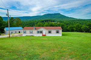 Your piece of the Ozark Mountains awaits! Near the Buffalo National River and approximately 2 miles to the Erbie Horse Camp, Erbie Campground, Cave Camp and Cecil's Cove, this property has rental potential. The manufactured home has many recent updates and the large deck overlooks your peaceful 20 acres. This 3 bd, 2 bath home has a game room that can be converted back to a 4th bedroom. The kitchen has new cabinets, granite/laminate countertops and stainless steel appliances with bamboo flooring. This property also features a 30 x 40 insulated shop w/ concrete floors & 2 overhead doors. A pond and a cave on property. Two miles gravel rd. has been well maintained. The 3rd bedroom is currently being used as a laundry room/office. The laundry room can be moved to the original location.