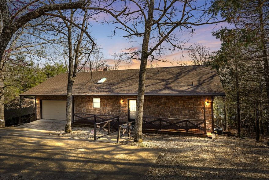 Lakefront living at its finest! This inviting home includes a private two-slip boat dock just a short, easy stroll away—perfect for lake lovers who want convenience and fun at their fingertips. The main level features an open-concept layout with a spacious kitchen, dining area, and living room under soaring cathedral beamed ceilings. The master suite is also on the main floor for easy one-level living. Cozy up by the fireplace, and enjoy the comfort of brand-new carpet and a brand-new roof. Downstairs offers a large family room, additional bedrooms, and a full bath—ideal for guests or kids. Step out onto the covered lower deck, complete with a hot tub for soaking under the stars. Just off the deck, a graveled area is ready for a firepit setup, perfect for evening s’mores and lakeside memories. This home blends comfort, charm, and lakefront lifestyle with room for everyone to relax.