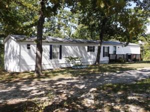 Beautifully decorated mobile home (all furniture stays) very well kept, large deck, 40x60 metal shop bldg. with electric, older log home on property detached garage, small chicken house, large pond with Koi fish, year round spring on back of property, good hunting (deer & turkey)