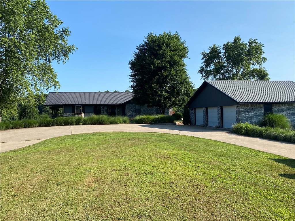 2,800 square foot home with in-ground pool overlooking War Eagle Creek. Four bedroom, office space, and three bathroom home sitting on 12.5 +/- acres. 140x50 shop with 11 bay doors and a 2 bedroom apartment for mother-in-law quarters or additional income. Shop includes car lift for vehicle maintenance. Roughly 800 feet of War Eagle Creek frontage with a beautiful sandy beach area. Less than a quarter mile to Withrow Springs Park entry and property borders this State Park at the river.