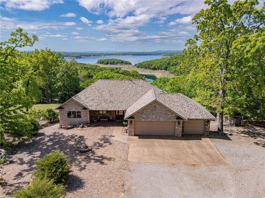 Discover an exceptional opportunity to own a stunning lake home on Bull Shoals Lake, complete w/ 2 boat slips in a community dock. Thisquality, custom-built home, cherished by its original owner, is set on a sprawling 3.75 ac m/l & features a 3-car garage alongside a spacious30x60 workshop. The home is in immaculate condition, showcasing an open-concept floor plan w/ soaring ceilings & beautiful wood-scrape flooring. The well-designed kitchen is equipped w/ triple viewing windows, granite countertops, and a large island. The panoramic lake views create an immediate sense of tranquility & belonging. Ideal for entertaining guests, the main level features two bedrooms, 2.5 baths, a cozy fireplace, and a composite deck with a pergola for outdoor enjoyment. The lower level includes 3 additional bedrooms, a second fireplace, a recreational room, a hobby space, heated floors, covered patio, and a storm room and a 10k watt generator. A comprehensive highlight list is available upon request.