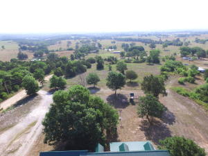 Very nice home with an amazing view! 3BR, 2.5BA with another bonus room that just needs a closet to be a 4th BR, Master suit, 1/2 bath, living space, and utility room all on main floor, 2 car attached garage, covered front porch to set a look at the view to the East. Comes with about 7 acres to be surveyed. New flooring and paint and ready to move into.