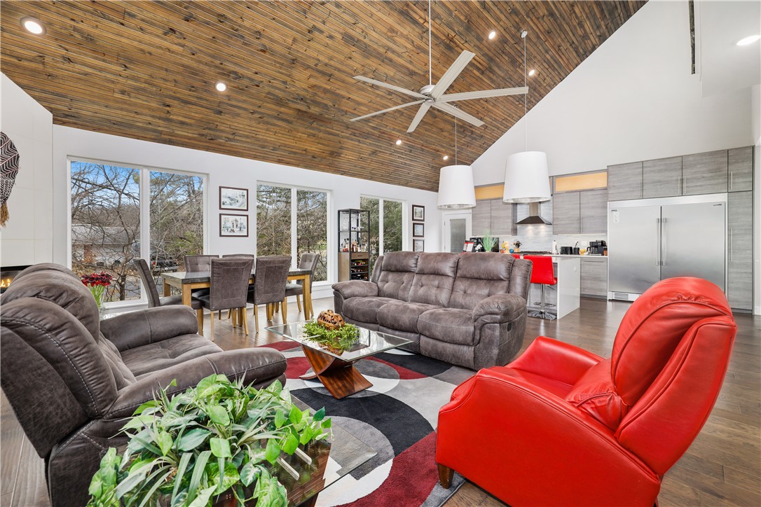 This property is the entertainer's dream! It is a sleek and sophisticated two-story contemporary home in Midtown Fayetteville. Adorned in natural light and boasting beautiful views of the city. The wood ceiling soars through the open living area highlighting a 72 inch industrial fan. The spacious modern kitchen features premium Italian custom cabinets with stainless hardware and soft-close technology. As well high-end stainless steel appliances, a built-in beverage cooler and a breathtaking waterfall quartz countertops. The master suite has all the amenities, plus the most gorgeous double rainfall shower. Above the living room is the interior balcony! The balcony spaciously opens to the rooftop terrace via the automatic glass sectional garage door. The 650 square foot terrace includes an outdoor kitchen, living area, small garden and a five person jacuzzi! Let the good times roll and the energy impact stay low because this home comes with a solar power system too! This home has it all! Schedule your showing today.