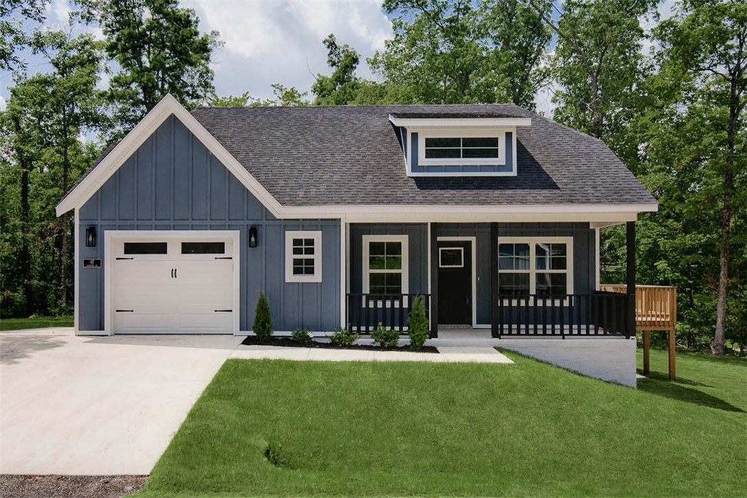 MOVE-IN READY! Discover this stunning new cons't craftsman style home located near Pinion Creek Falls, The Back 40, and Lake Ann. Bentonville schools! This exquisite home sits on a FLAT .29 acre wooded lot and boasts high-end finishes throughout! Step inside to find a stylish open-concept layout, adorned with LVP floors. (no carpet) The focal point of the home is the kitchen, equipped with custom cabinets, a wood hood, luxurious countertops, and a large kitchen island. You'll love cooking with premium black stainless steel appliances, including a gas range. Retreat to the primary bath, where you'll find a spacious walk-in tile shower & double vanity. 2 bedrooms / 2 baths. Plus, take advantage of $3,500 in buyers closing costs, courtesy of the builder's preferred lender! Put "36.477285, -94.228052" into your GPS.