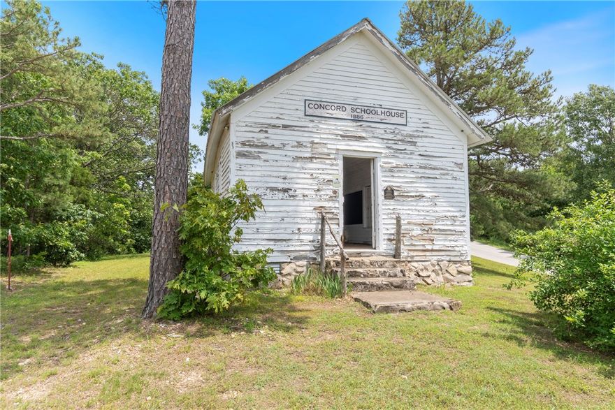 This charming cabin is a Successful AirBNB rental offering three bedrooms and 1.5 baths, with the third bedroom currently used for storage. Rich in rustic character, the home has been thoughtfully updated with quartz bathroom countertops, new shower/tub, 2” blinds, a fenced backyard, gutter guards, RV hook-up, and a new washer and dryer. The well has been recently serviced, adding peace of mind for the next owner.

Also included is the historic Concord Schoolhouse — a true piece of local history. This original one-room schoolhouse features a new roof and was once used as a wedding venue. With its character and charm, it’s ready for restoration as an event space, studio, or something entirely your own.

With no restrictions and being sold fully furnished — right down to the dishes — this property offers endless possibilities: continue the successful Airbnb, host events, create a unique venue, or simply enjoy it as a private getaway near the river.