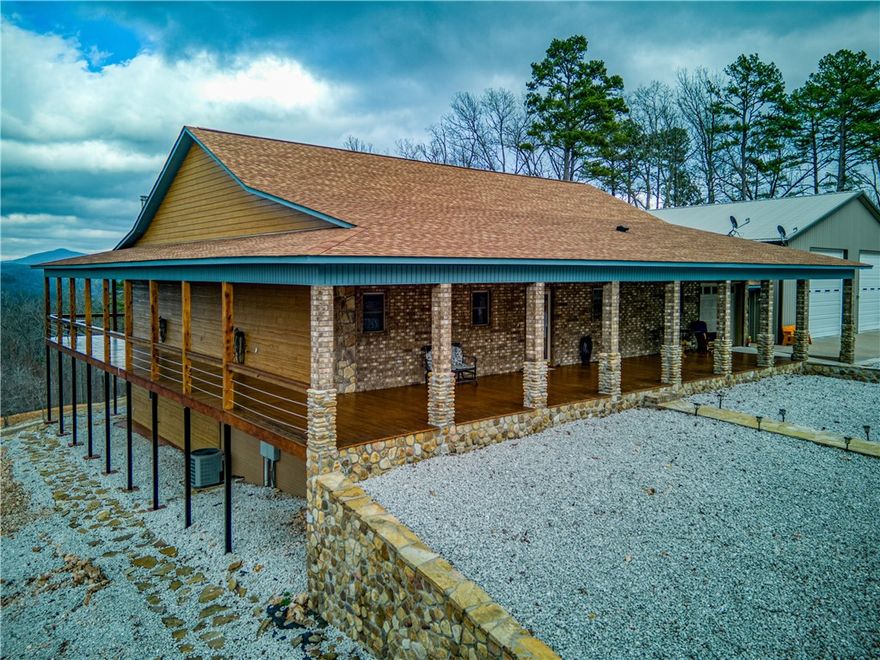 This  property  borders the National Buffalo River Park. The floating input is just a half mile away.  Property is fenced with gates at the paved road and landscaped with gravel for plenty of parking.  It has B & B potential and outdoor activities   The RV garage has fully furnished  460 sq ft apartment . Maintenance is low with smart no paint siding with lifetime warranty, stone, and metal exterior.  Upon entering the inside you view soaring rock fireplace, gorgeous pine, cedar, walnut walls, custom  cabinets , hickory floors, tile and LVP for easy maintenance. Storage  is fantastic with utility and pantry off kitchen. In master bed and bath : his and her closets, copper sinks, walk in jacuzzi & shower, There are beautiful views from windows and decks overlooking forest and raised bed gardens with paths through fruit trees, perennial flowers, roses, Dogwood trees and  sidewalks all around. Covered storage for any equipment,  storm shelter and more room for outdoor gear or decor, equipment, garden tools and more.