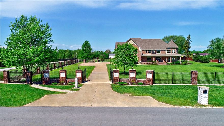 Welcome to your dream mini-farm where luxury meets country living! Situated on 3.19-acre, property is gated & fully fenced. An elegant double door entry w/gas lamps welcomes you inside to 2-story grand entrance w/circling staircase, 4900+ sq. ft boasting 5 full BRS upstairs & a BR/Office conveniently located on the main level. Formal LR & dining room are large w/lots of natural light. The beautifully crafted kitchen has ample seating space open to a family rm & dining area are perfect places for any gathering. The primary suite is on 2nd level is a true retreat, featuring a jetted tub, walk-in shower, 2 separate walk-in closets. There is no shortage of space! Other features: 2 staircases, crown molding, hickory wood floors, & a butler pantry, 609 sq ft pool house w/covered patio, in-ground pool, upscale chicken coop, raised gardens- everything you need for outdoor entertaining & fun. Even more: 4800 sq ft, 4-car garage/workshop w/loft. Minutes from Spr'dale & F'ville, 25 minutes to XNA, Rogers & B'ville. Must see!
