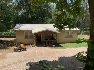 Great location. Come see this 800 ft2 1975 model 3 bedroom 1 bath home on 2 acres. Large shade trees, rural water, OzarksGo fiber optic for the remote worker, newer metal roof, newer subfloor with carpet and laminate, separate electrical for RV hookup. Only 15 minutes to Huntsville, 35 minutes to Fayetteville. With some TLC this solid built home could be a gem. Where can you find a home with all utilities on acreage at this price point? Don't delay and regret it. This home is sold AS-IS.