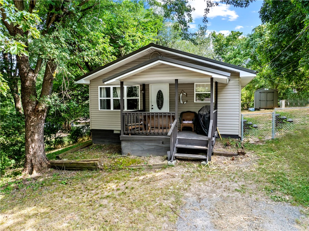 Well maintained 3- bedroom, 1-bath home offering 1000 sq ft of living space. Updates include siding, windows, and roof, all replaced approximately three years ago. The property features a fenced-in backyard, a storage building, and mature trees that provide ample shade. Convenient location with a functional layout.