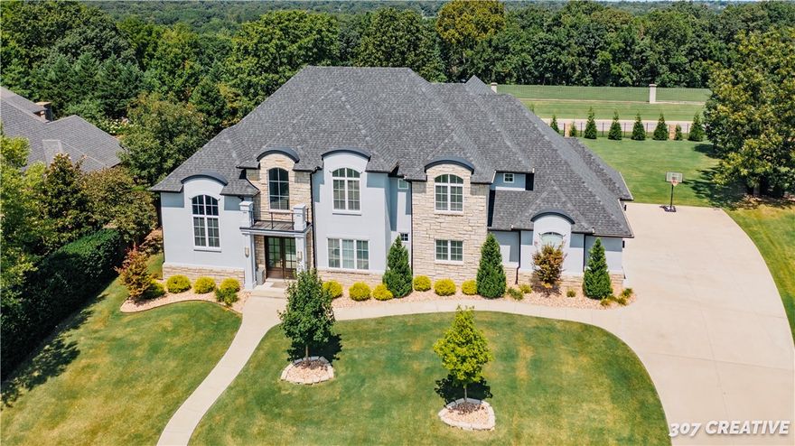 Contemporary newer home sitting on .58 acre lot. Walk into an exquisitely designed home. This home boasts  open living area, distinctive gourmet kitchen with high-end appliances. Each bedroom has a walk-in closet and private bathroom. ITS' state of the art office space sits on a transitional floor. Over-sized master suite, work-out room and wine cellar are all conveniently on the main level of this upscale and modern home. Enjoy sunsets in a gorgeous and tranquil outdoor living space w/built-in grill and burners. Luxury home living in the heart of NWA.