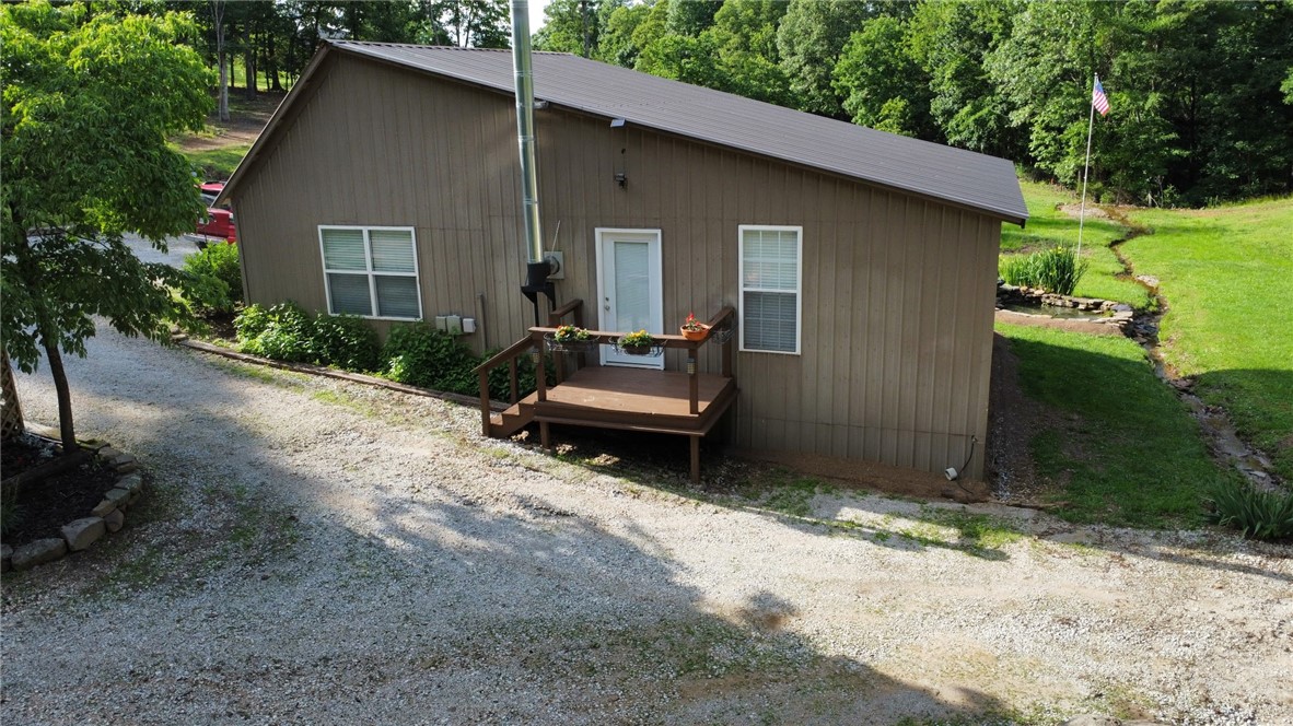 Tucked in the hills of Madison County, this beautifully remodeled 3-bedroom/ 2 bath home sits on 10 peaceful acres. Renovated top to bottom in 2016, it features energy-efficient upgrades throughout.
Carefully planned with ease in mind, the property offers a complete auto irrigation system servicing the garden, flower beds, and chicken house doing the hard work for you. The impressive two-story chicken house includes solar-powered doors, a zap fence, open air runs and a terrace, and separate bays for breeding, hatching, and living. The perfect homestead setup.
The acreage offers mature timber and lots of wildlife.
An abundant spring water system and pump house supplies the home and land, giving you, off-grid potential all while staying within reach of available WiFi. Whether you’re raising livestock, growing your own food, or simply seeking a more simple life outside of town, this property is perfect for you.