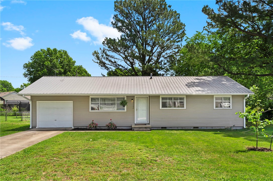 Welcome to comfort, convenience, and charm in this delightfully updated 3-bedroom, 1-bath home! Enjoy the warmth of solid hardwood floors and the peace of mind that comes with major upgrades, including updated kitchen and bathroom, completely re-wired with new electrical panel and new HVAC units installed in 2020, plus new service lines for gas, sewer, and water for improved longevity! Move-in ready with refrigerator and washer/dryer included, plus the added convenience of a motorized garage door. Situated on a spacious, level lot, the yard is ideal for outdoor play or even a future addition or ADU (Accessory Dwelling Unit). Located in East Fayetteville, you’re just minutes from Whole Foods, Harps. With excellent access to Mud Creek Trail and Ozark Regional Transit Route 10 and On-Demand services, this home offers a realistic and affordable option for car-free living. Schedule your showing today and imagine the ease and comfort of calling this home your own!