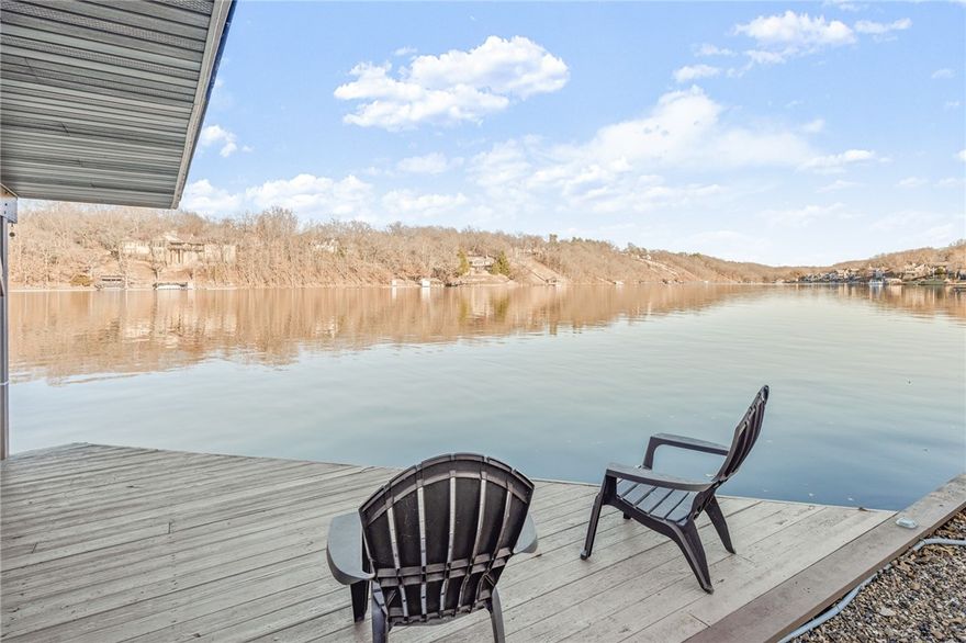 Spring is in the air! Time to buy a one of a kind lake home! This home on Loch Lomond sits on .5 acres and comes with private covered boat dock and an expansive year-round view. Boat house is just a short, flat walk to the water! After the 2021 renovation, this home now offers ALL THE THINGS! Enjoy quiet mornings in the heated and cooled sunroom overlooking the lake. Custom kitchen with granite countertops, high-end appliances, KitchenAid cabinet and lake-facing wash sink. Primary bedroom offers private deck, an ensuite bath with soaker tub, walk-in shower with frameless door and bench, vanity and custom linen cabinet. New LVP flooring, faucets, hardware and LED lighting throughout. In 2023 a Google Nest Thermostat and several Pella windows were installed. In 2022, a 6,000lb boat lift was installed and seawall and boat dock were restored. Walkout basement offers two bedrooms, full bath, wet bar, bonus room, storage rooms and a multi-functional flex space great for indoor gardening, workshop, lake equipment, etc.