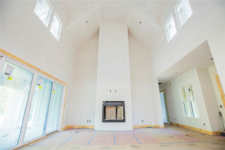 Soaring ceilings, ample windows, and a large lot make this light filled home a downtowner's dream.  Bike to the farmer's market and prepare gourmet meals in your open kitchen, enjoy company in the spacious living room, or retreat to the patio out the massive French sliding glass doors to catch a sunset in front of the outdoor fireplace.  Don't miss the craftsmanship of the custom cabinets, the wood floors, the vaulted ceilings, or the designer color scheme.  This home really does have it all--4 bedrooms and 3 baths all on the main level, plus a mud room and office nook.  Upstairs you will find a landing and a bonus room full of possibilities. Great location where you can easily enjoy the best restaurants, nightlife, and local shopping. If nature is your thing hit the mountain bike trails or stroll to the park with your furry friends.  Then clean them up in the built in dog shower.  Just minutes from the trail system. Crystal Bridges, several neighborhood schools, and the dog Park!