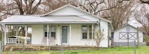 This adorable home sits on a 1.5 acre fenced in lot. Perfect location, a corner lot just outside of the quaint town of Hartman. Enjoy relaxing on the deck or front covered porch. The large yard is beautifully landscaped and has a double carport, an additional carport, and a shop. 2 living rooms and one could easily be used for a 3rd bedroom. The owners have made a lot of beautiful updates to this move-in ready home! Open floor plan, vaulted ceiling, and kitchen appliances convey. Home is an absolute must see! Sellers have priced home to sell!! Call and set up your personal tour today!