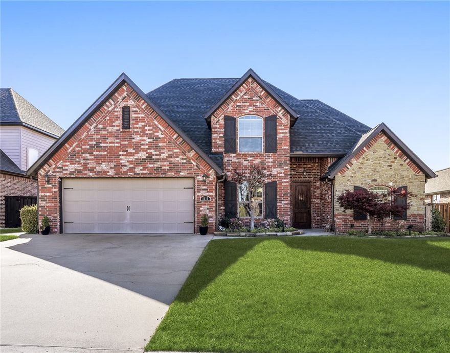 Luxury living in Bentonville’s premier neighborhood! Conveniently located to all of NWA attractions, this all-brick, two-level home combines elegance w/functionality. Step inside to an inviting entryway adorned w/stylish moldings & a graceful archway opening to living area. Living rm features soaring 2-story ceilings accented by a cozy fireplace contributing to the sophisticated ambiance. The main level hosts the primary suite, a dedicated office w/custom built-in, formal dining & 1/2 bath for guests. Hidden leads staircase to a versatile bonus rm & full bath,3 bdrms w/gracious closets, including an ensuite. Highlights include no carpet in common areas, quartz counters,natural light, EIK, a three-car tandem garage w/utility sink, irrigation system, central vac & tons of storage. Outside covered patio is crowned by a high, wooden-planked ceiling w/a modern 6-blade fan, pull down shades, tv hook ups & built in grill area. Patio opens up to flat yard lined trees! Subdivision amenities w/pool!