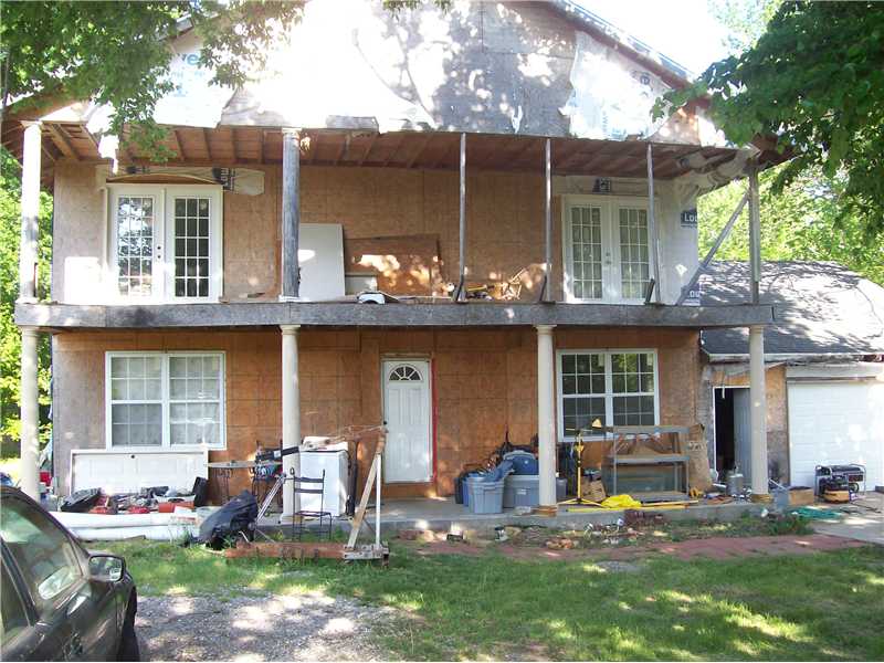 Seller has started this new construction in 2005, and has been working on it in spare time. Upstairs is almost completely finished, outside needs siding,brick or whatever.downstairs is livable but still needs some wallboard &ceiling,flooring completion.,House is lived in, has all new electrical & plumbing to the street, Insulated, 2 new heat pumps, hardwood floors in upstairs. big master suite! 4 bedrooms and master bath up, 2 bedrooms 2 baths down.1/2 bath has commode&is plumbed,full bth plumbed too.