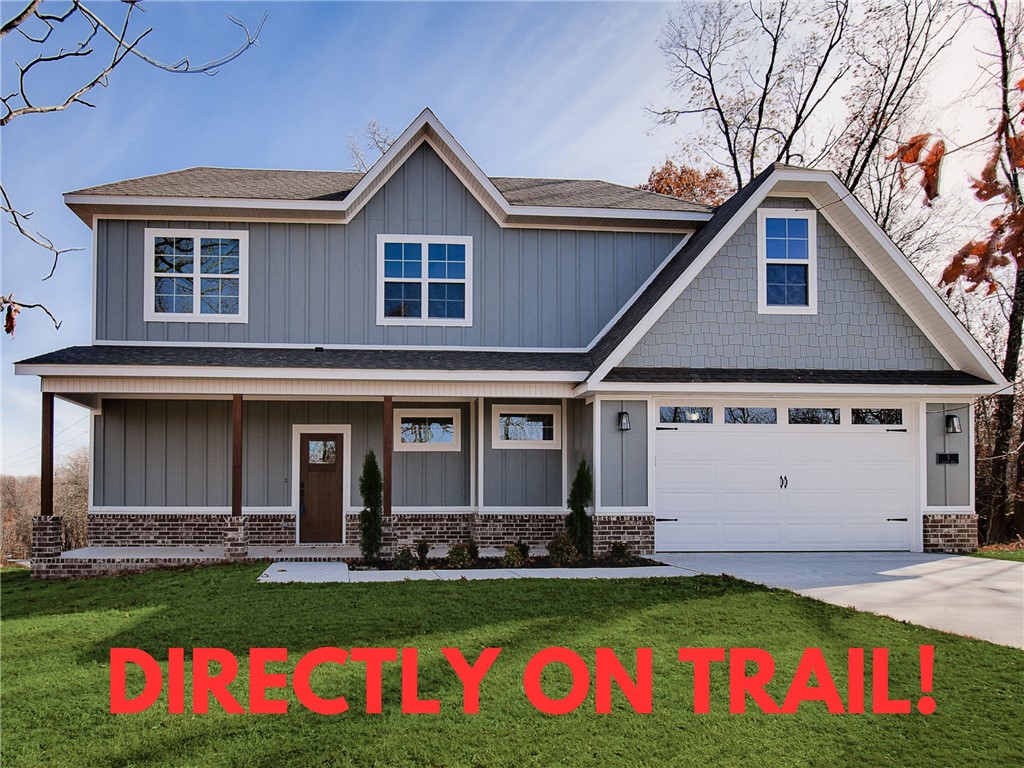 Check out this beautiful new construction with a bonus room on a wooded lot directly on the bike trail! This stunning property offers the perfect blend of nature and nearby amenities. Conveniently located a few minutes to Lake Ann and close to the Back 40 Trailhead. Step inside to discover wood floors, a beautiful fireplace, custom cabinets, and elegant 3 cm quartz countertops. The expansive kitchen and gas range is perfect for culinary creations. This thoughtfully designed home features 3 spacious bedrooms plus a versatile bonus room, providing ample space for entertainment. The primary bedroom is conveniently located on the main level. Bentonville schools! As an added bonus, this home includes $3,500 in buyer's closing costs when using the builderās preferred lender!