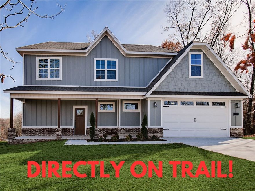 Check out this beautiful new construction with a bonus room on a wooded lot directly on the bike trail! This stunning property offers the perfect blend of nature and nearby amenities. Conveniently located a few minutes to Lake Ann and close to the Back 40 Trailhead. Step inside to discover wood floors, a beautiful fireplace, custom cabinets, and elegant 3 cm quartz countertops. The expansive kitchen and gas range is perfect for culinary creations. This thoughtfully designed home features 3 spacious bedrooms plus a versatile bonus room, providing ample space for entertainment. The primary bedroom is conveniently located on the main level. Bentonville schools! As an added bonus, this home includes $3,500 in buyer's closing costs when using the builderās preferred lender!