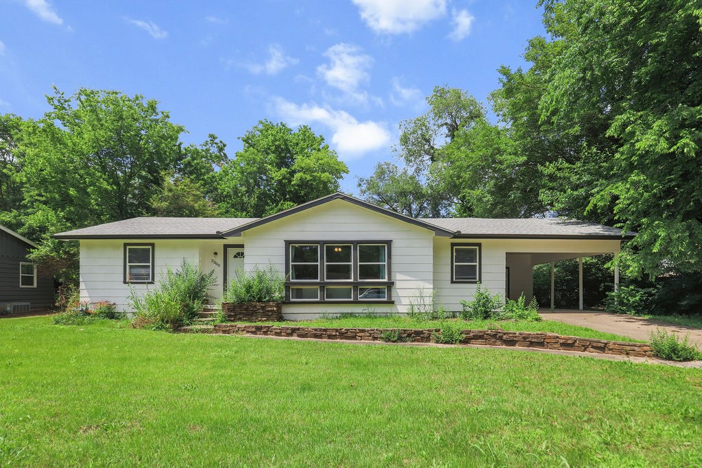 Discover this beautifully renovated home, perfectly positioned near the University of Arkansas, vibrant Dickson Street, and Razorback Greenway, where modern updates meet comfortable living. This property has been thoughtfully transformed with fresh interior and exterior paint, creating a move-in ready atmosphere. The kitchen features completely new cabinetry and appliances, while updated bathrooms showcase all new modern fixtures. Quality improvements include new LVP flooring, LED lighting, upgraded plumbing, and double-pane vinyl windows. Amenities include washer/dryer hookups, ceiling fans in bedrooms, and a one-bay carport. The new sliding glass door opens to a step-down deck overlooking the private backyard with mature trees and full chain link fencing. Additional storage provides extra convenience. Schedule your personal tour of this perfectly located and beautifully updated home today.