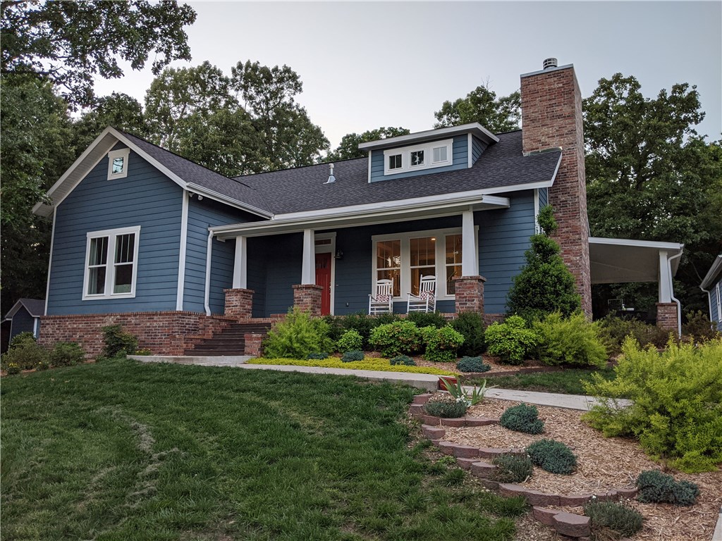 This charmer has the best of all worlds - 1920's bungalow style but with modern conveniences AND the privacy of 5.5 wooded acres but less than 10 minutes from I49! Great floor plan with real 3/4" hardwood floors throughout the main floor, a beautiful wood burning fireplace, and roomy kitchen and dining area perfect for entertaining. Upstairs you'll find a 2nd living room with playroom around the corner, a large office that could be used as a bedroom, den, school room, etc. Large windows bring in the outdoors, and, in winter, allow you to take in the view of the mountains! Vacation every day on the large porches, which provide natural light inside without the heat. Other unique features include an 5'x8' in-ground storm shelter under the stairs, oversized detached garage deep enough for any vehicle and room to spare for a shop or exercise area, AND approx 400sf heated/cooled finished room above garage (NOT included in total living area sf) with full bath under the stairs! Nearly 3,700sf of finished area total!