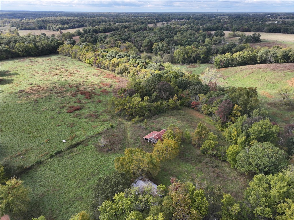 This stunning property is 96.55 acres. Attached drone photos and video illustrate the meadows, wooded areas, pond and creek. Wildlife and wildflowers coexist here. Property has a house 1008 Sq. ft. 3 bedroom 1 bath built 50 plus years ago. This property also wraps around the intersection of Callis and Bullock roads. All utilities are off and home has recently been winterized since renter moved out in November