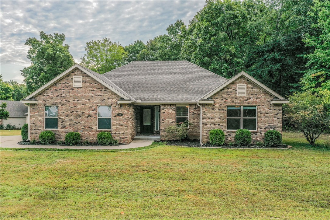 Charming 3-bedroom, 2-bath home in Bella Vista with 1,530 sq ft on a rare level lot! This well-designed split floor plan offers comfort and privacy, while the spacious living areas make it easy to entertain. The kitchen flows seamlessly into the dining and living spaces, and the primary suite is tucked away for relaxation. The large back patio faces a private wooded area perfect for entertaining. Enjoy the convenience of a two-car garage plus a storage building for all your outdoor gear. Located within walking distance to Bella Vista’s renowned bike trails, this home is perfect for those who love both comfort and adventure. A rare find in a sought-after location!
