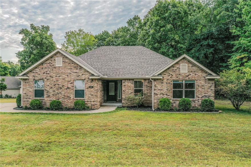Charming 3-bedroom, 2-bath home in Bella Vista with 1,530 sq ft on a rare level lot! This well-designed split floor plan offers comfort and privacy, while the spacious living areas make it easy to entertain. The kitchen flows seamlessly into the dining and living spaces, and the primary suite is tucked away for relaxation. The large back patio faces a private wooded area perfect for entertaining. Enjoy the convenience of a two-car garage plus a storage building for all your outdoor gear. Located within walking distance to Bella Vista’s renowned bike trails, this home is perfect for those who love both comfort and adventure. A rare find in a sought-after location!
