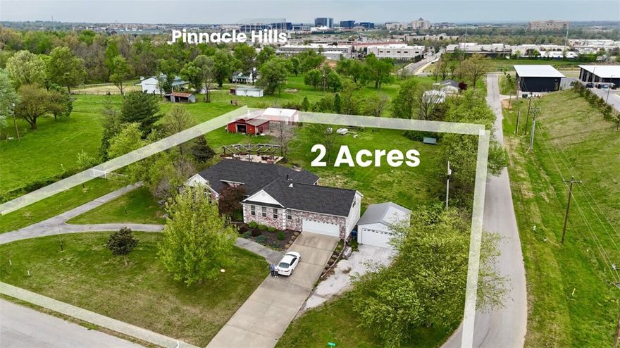 Positioned perfectly at the intersection of rural living and massive commercial upside, this 2-acre property represents one of the most compelling investment opportunities in Rogers. Located between Perry and New Hope road, this property sits directly in the path of progress. With retail development already established to the west, the expansion toward 30th Street is just a matter of time.

The property is uniquely situated near the site of the upcoming professional soccer stadium and planned retail hubs. Future city planning includes a street pass-through that would further enhance accessibility and value. While you wait for the commercial transition, enjoy a meticulously maintained 2,870 sq ft home featuring two living areas,  inground pool, expansive patio, 3-stall horse barn, a shop, and a 4-car garage. Whether you choose to hold as a primary residence, utilize it as a high-end rental, or hold for the future, the equity potential is undeniable. Bring your offers and secure your stake in the future of Rogers.