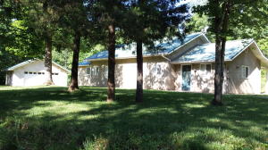 Home and 3.79 acres! This 3 bedroom, 2 bath home is in nearly new condition, has a large kitchen, oversized two car garage, gas fireplace, covered patio, low maintenance exterior, metal roof, and is in the Bergman School District!