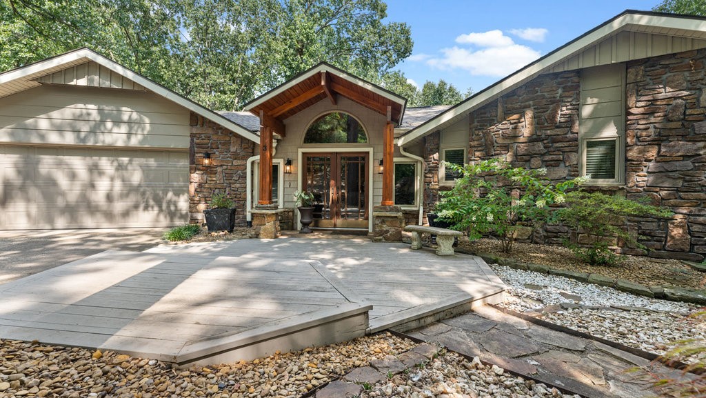 Welcome to your Lake Windsor dream home! Nestled in the trees, this custom-built home is full of character and beauty. With its wood-adorned custom architectural accents and color palette that blends seamlessly with the beauty of its natural surroundings, this home is one-of-a-kind. The house is nestled in a peaceful and private cove of the lake. The newly redone boat dock is huge with a storage building for water toys. Multiple deck options on the home allow everyone to have their favorite space to be outside enjoying the view of the water and the beautiful trees that abound. Inside, offers multiple living spaces ready for gatherings of all sizes. The enormous kitchen is sure to delight the chef of the house- and who wouldn't love to cook with this view? The primary suite sits on the main level with its own screened deck. The lower level has two more living spaces, a wet-bar, the bedrooms, an office space, and storage. This home truly has it all! 1.8 miles to 71B; .2 miles to trails; .8 miles to Tanyard Creek!