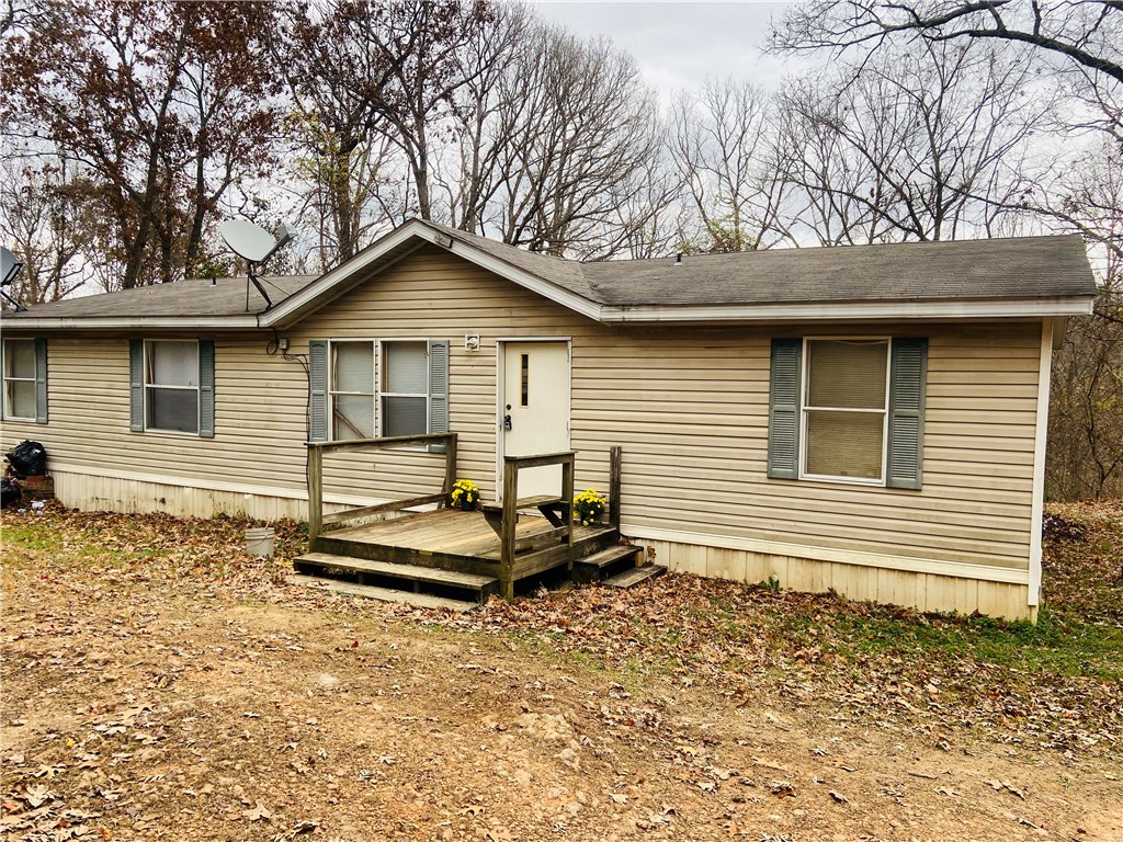 3 Br 2 bath double wide 1568 sq ft ( 56x28) built in 2002 on 1.97 acres. Newer laminate flooring throughout. Private and secluded on one of the largest lots in subdivision. Wood burning fireplace, gas run to just outside mobile and could be converted. Split floor plan, large living area, open concept. Master bath has garden tub, walk in shower and double vanities. This mobile is āAs isā. Mobile personal property, no finance option known of. Hot water heater new in 2020.