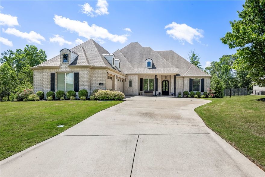 Gorgeous, LIKE NEW Versailles home. This 4 bedroom, 4 bath home has so many amenities! Almost one full acre of privacy. The kitchen: expansive counters, abundance of storage, soft close drawers and cabinets, ice maker, gas cooktop, drawer microwave in the oversized island, commercial size refrigerator, beverage refrigerator, double ovens, generous walk in pantry. Very open plan with amazing natural light. Large breakfast area, long island bar space and a formal dining room. Primary suite: you will fall in love with the spa feeling of the bath and the biggest closet you will find that opens to the laundry for easy access. A second suite is on the opposite side of the home with its own bath and a private patio entrance. Two more bedrooms and another full bath are toward the front of the home on the main level as well. The upstairs houses a HUGE bonus space that can be used in so many ways, full bath, closet and two walk in attic spaces. Outside is a very private covered patio with fireplace and expansive lawn.