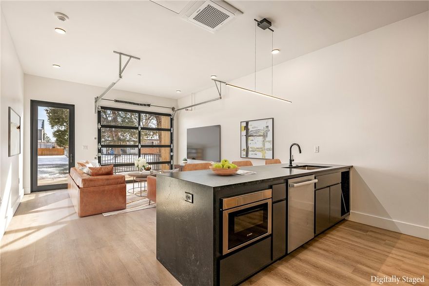 The Basquiat Flat offers a rare opportunity for downtown Bentonville living with flexibility. This one-level, one-bedroom condo with flex room blends industrial character with modern comfort and is one of the few units in the building approved for short-term rental. A distinctive roll-up garage door opens to your private patio, creating an effortless indoor-outdoor vibe that lives larger than expected. Bright and airy with an urban feel, the bedroom comfortably accommodates a king-size bed and features a generous walk-in closet. The bath is thoughtfully upgraded with a floating white oak vanity, custom tile work, and a spacious soaking tub. An oversized laundry room adds practicality rarely found in condo living. The unit includes reserved off-street parking and an attached 8x6 interior storage room (not included in sqft)—ideal as an owner’s closet or secure bike storage. Perfect as a primary home, second residence, or investment opportunity.