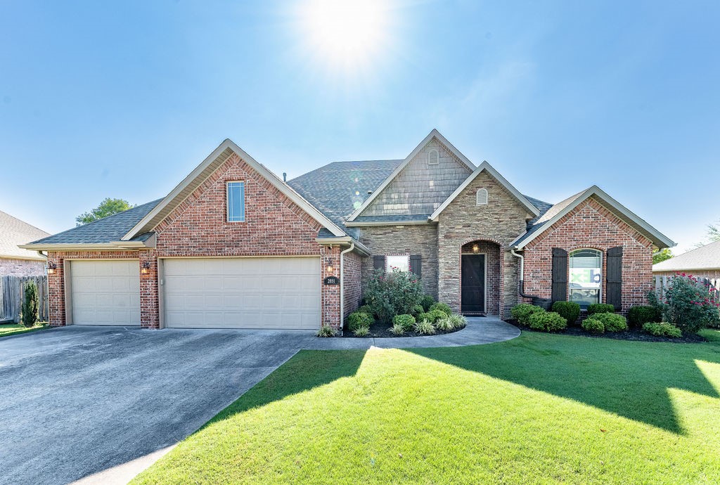 Centrally located in West Fayetteville, this beautiful 4-bedroom, 3-bath home with a 3-car garage is minutes from Holcomb Elementary, Holt Middle School, Fayetteville High, the University of Arkansas, and major shopping with easy I-49 access. The split-bedroom layout offers spacious, light-filled living and dining areas while maintaining privacy. The chef’s kitchen includes a formal dining room, breakfast nook with views of Underwood Park, custom cabinetry with rollout shelving, large island with bar seating, and top-tier appliances (included with accepted offer). The living room features soaring beamed ceilings, large windows, and a gas log fireplace with built-ins. The primary suite offers a walk-in shower, jetted tub, dual vanities, and a custom walk-in closet. Enjoy the covered patio with a gas fireplace and grill hookup. Quality finishes throughout include wood flooring, tile in wet areas, carpeted bedrooms, and quartz countertops.