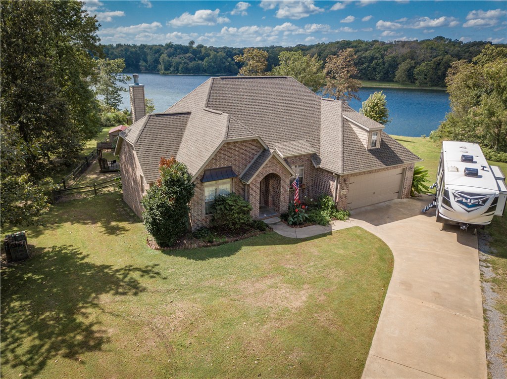 LIVE ON THE LAKE! Offering uncommon character, this custom built 3 bedroom 2 bathroom home with bonus room sits on just under 1 acre of lake frontage! Enjoy the wood burning built-in fire place on your covered back porch over looking the lake while you watch the Eagles fly at sunset! Partially fenced backyard is great for pets and small kids includes above ground pool, Pergola covered patio, and outbuilding for tools/storage! Bonus room could be used as 4th bedroom/Office/Hobby space!