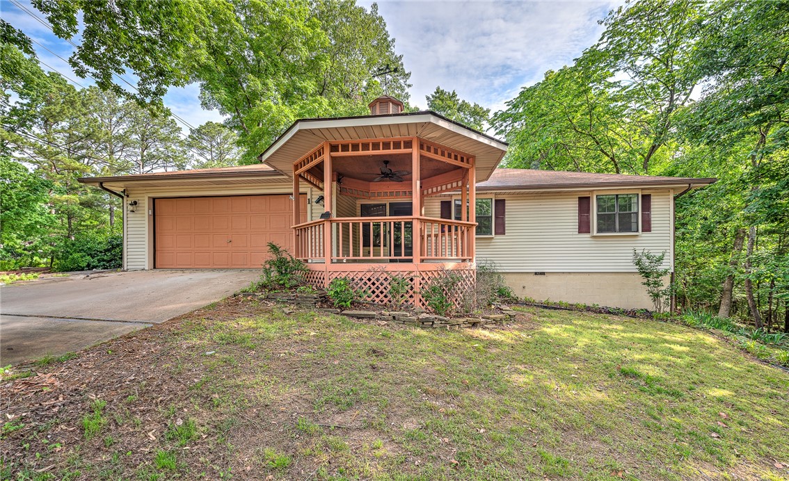 Just minutes from trails, golf, lakes, dining, and shopping, this beautifully maintained home blends convenience and comfort. Updated in 2020, the interior features neutral paint, modern lighting, upgraded hardware, and enhancements throughout the kitchen, baths, living spaces, and sunroom. Enjoy generous built-in storage, a climate-controlled walk-out workshop, and an oversized two-car garage with bonus workspace or office. Outdoor living shines with a spacious rear deck, covered front porch with gazebo, and an all-season sunroom with oversized sliding windows. Set on a landscaped lot with mature trees, this move-in-ready home offers both style and serenity.