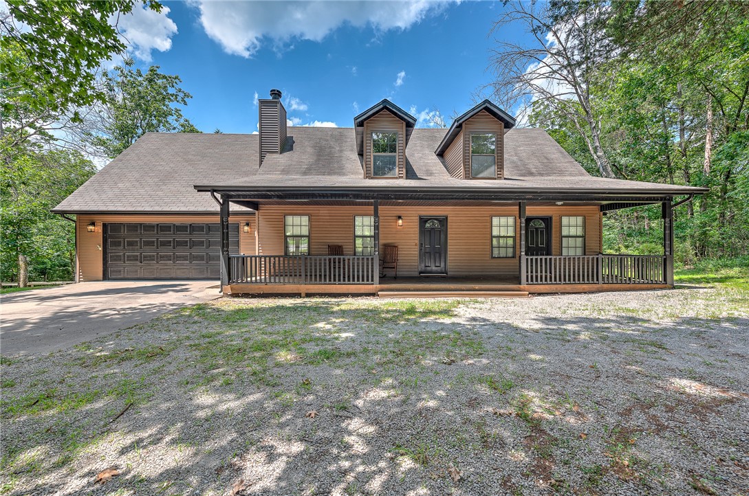 This two-level Holiday Island home is tucked into a peaceful, tree-filled setting on a spacious corner lot thatās mostly flat with a gentle slope. Surrounded by nature and just moments from the park and scenic Starlite Trail, it offers the kind of quiet and privacy thatās hard to find. The large, wooded backyard features several walking trails that wind through the trees and lead to a peaceful creek, perfect for morning strolls or quiet reflection. A warm, wood-burning fireplace and built-in wet bar make the living space cozy and inviting, while the open layout brings in natural light and views of the trees from nearly every window. Community perks include access to the nearby park & playground. Whether you're seeking a full-time retreat or weekend getaway, this home blends comfort, character, and nature in one unforgettable setting. Come see why Holiday Island living feels better here.