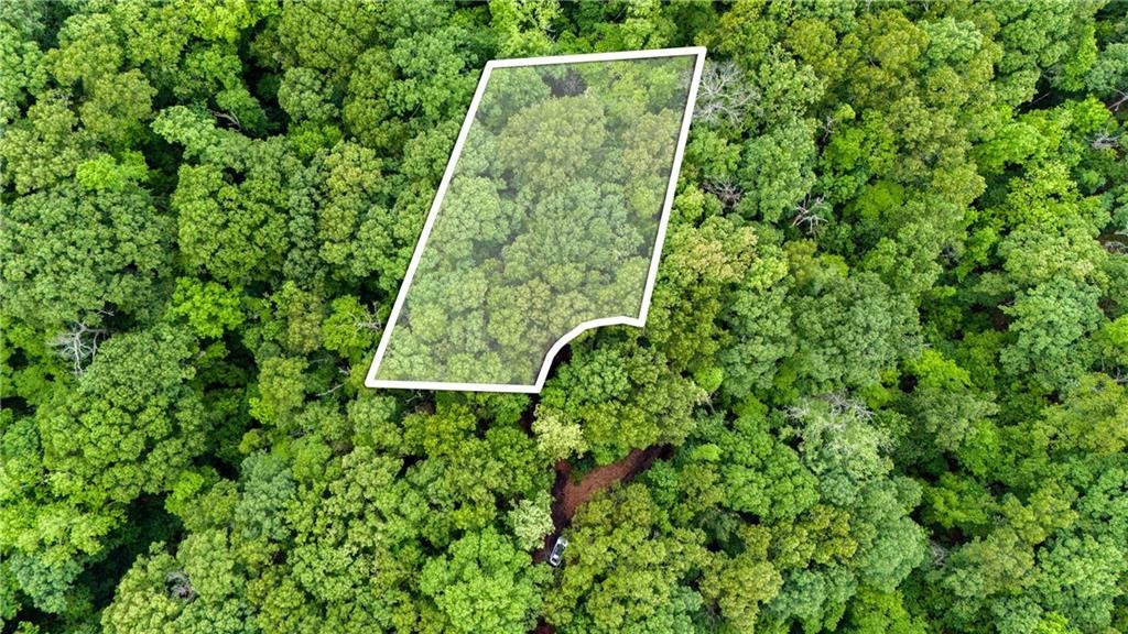 This premium parcel of land is ideally situated a mere mile away from the Branchwood Recreation Center, surrounded by a variety of recreational options such as walking trails, a lake, golf courses, biking trails, and easy access to I-49. It's the perfect place to construct your dream home. Nestled near Loch Lomond and the Branchwood Recreation Center and Trail, this plot lies at the end of a tranquil cul-de-sac and boasts a
gently sloping terrain offering a secluded and wooded ambiance. Lot has a recent topographical survey that will convey.