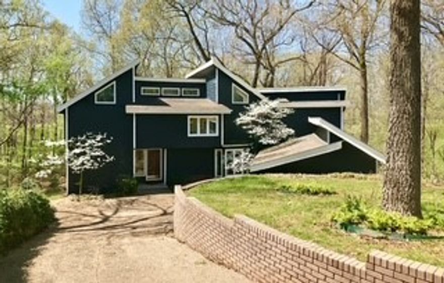 If you’ve been searching for a spacious home with character, flexibility, and big potential—this is it! Located at the end of a lovely wooded cul-de-sac, this Siloam Springs fixer-upper features 4 bedrooms, 2 full baths, a loft, and multiple main-level rooms that can serve as bedrooms, offices, or hangout spaces. The layout is ideal for multigenerational living or anyone needing room to grow. Cathedral ceilings and generous natural light highlight the home’s unique charm. Outside, enjoy wooded views, a quiet setting, and room to entertain. A sprinkler system and generator add value and peace of mind. Some interior projects were left unfinished, allowing the next owner to put their personal touch on the home and build equity with every improvement. Just 7 minutes from the historic and vibrant downtown of Siloam Springs, this home offers a rare combination of privacy, space, and opportunity!